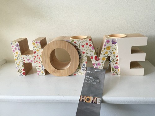 Next floral home tea light - next, "home"